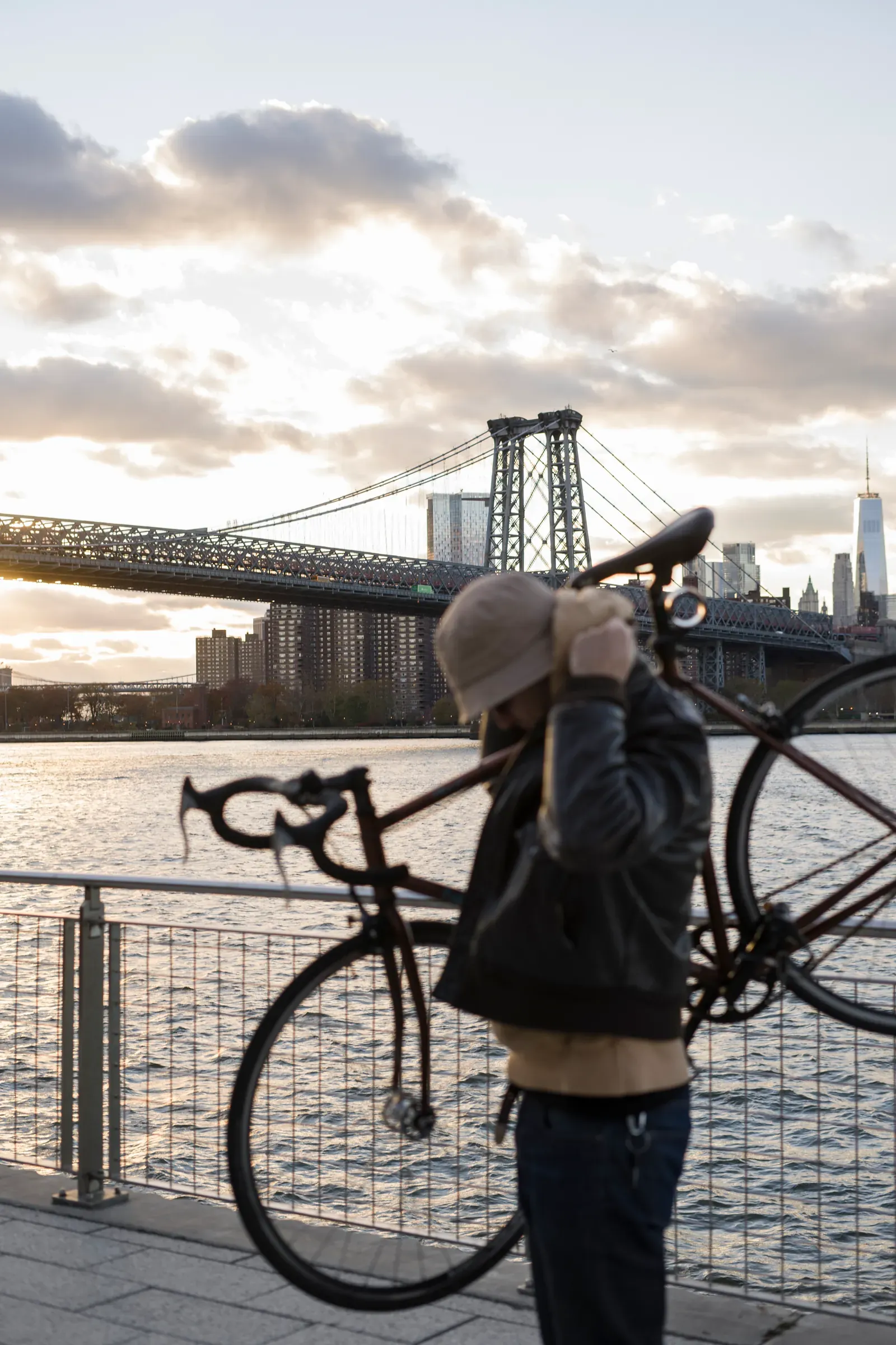 Cyclist on an urban bridge crossing at dusk